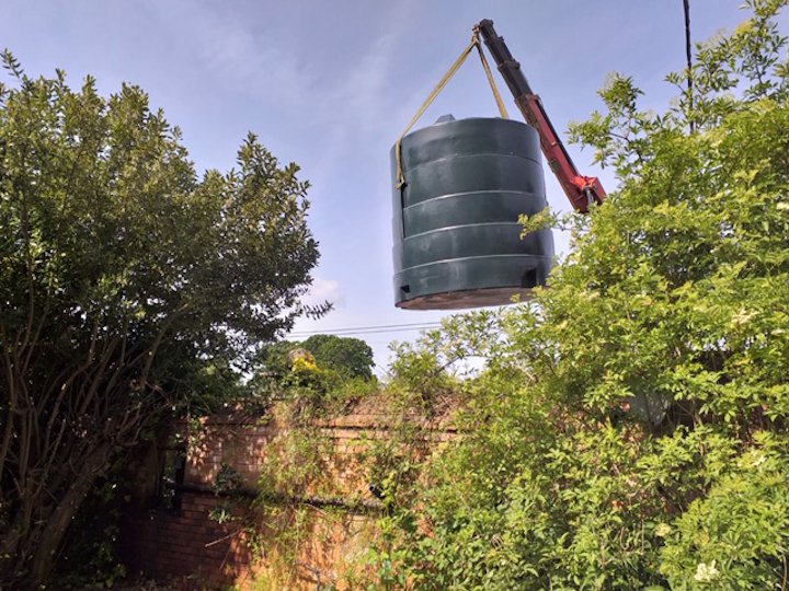 Oil tank removal with crane